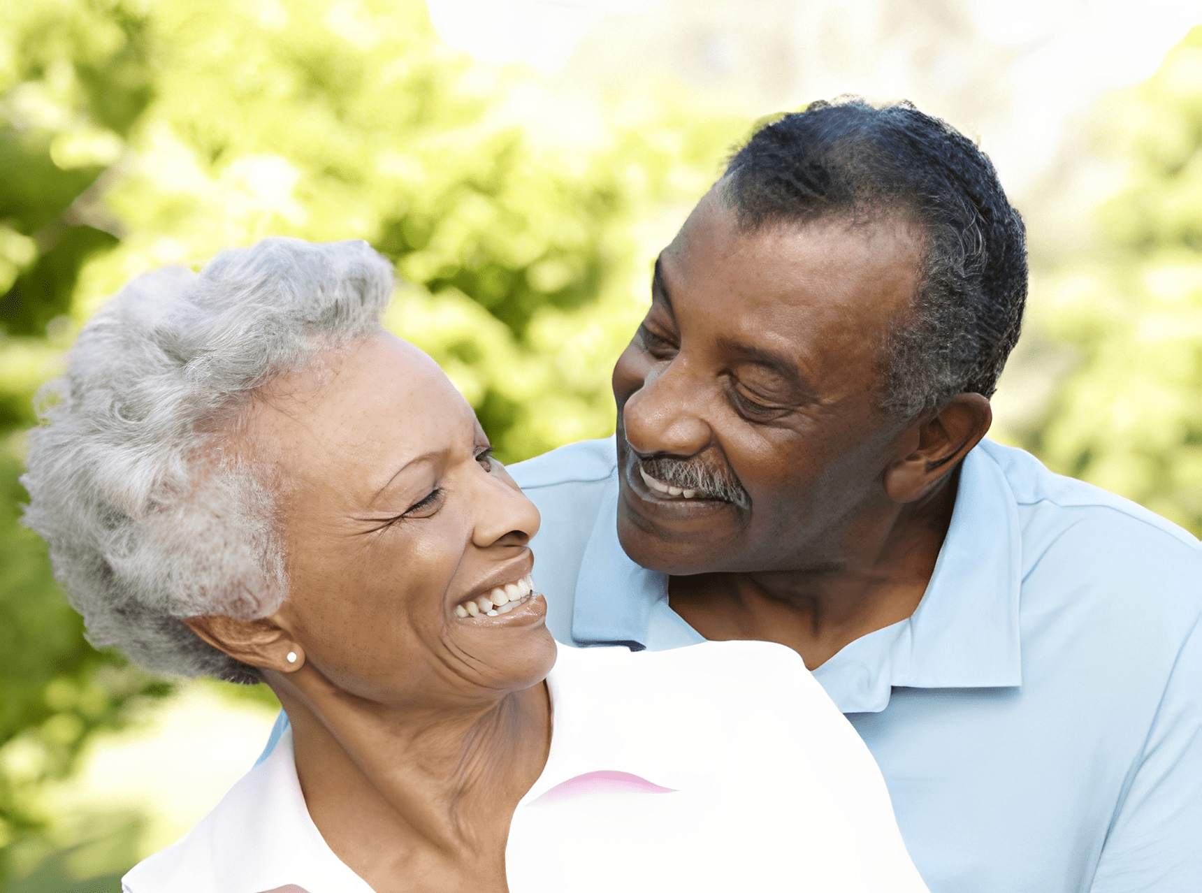 Elderly couple smiling outdoors