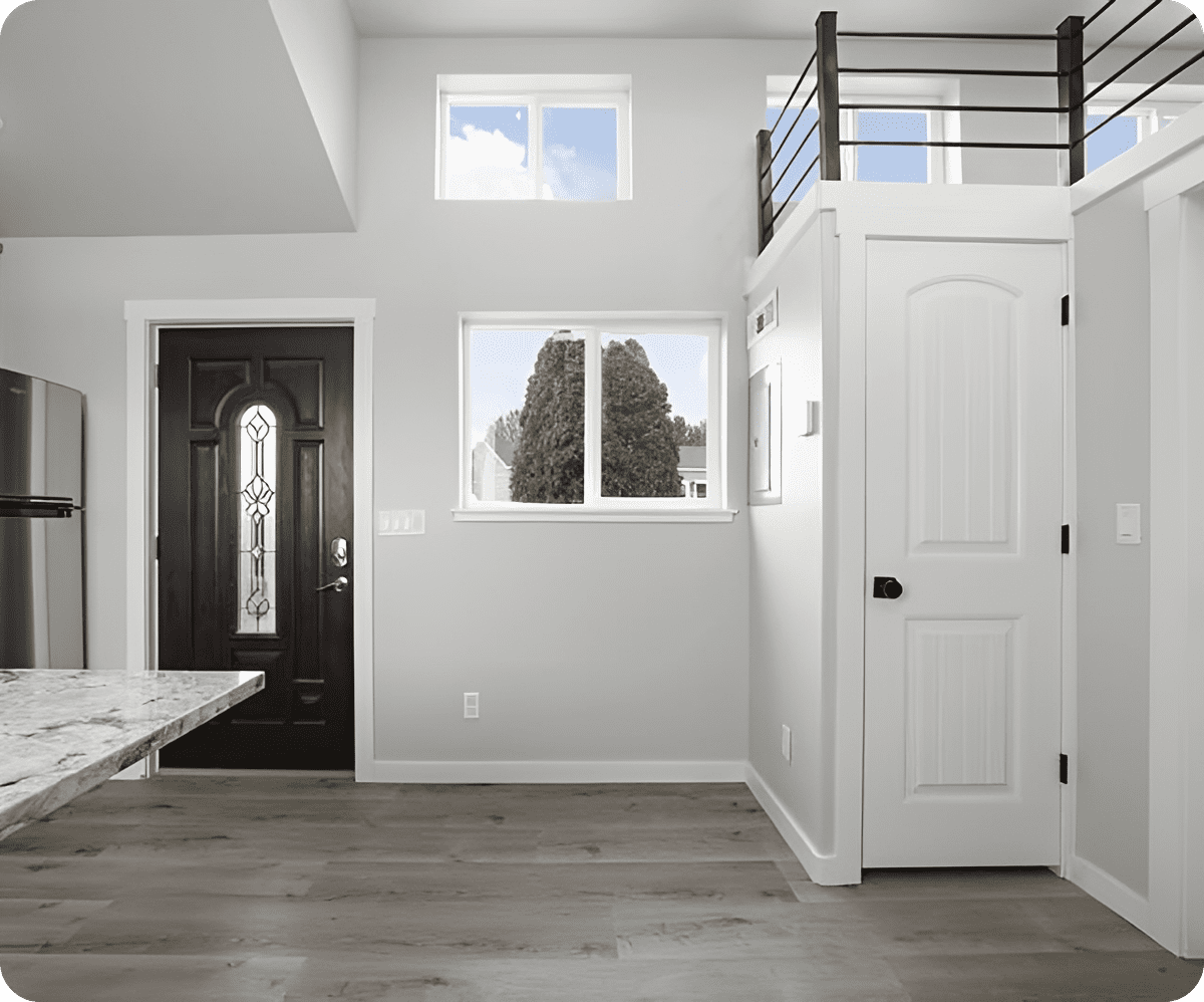 Minimalist space with wooden floors and loft.